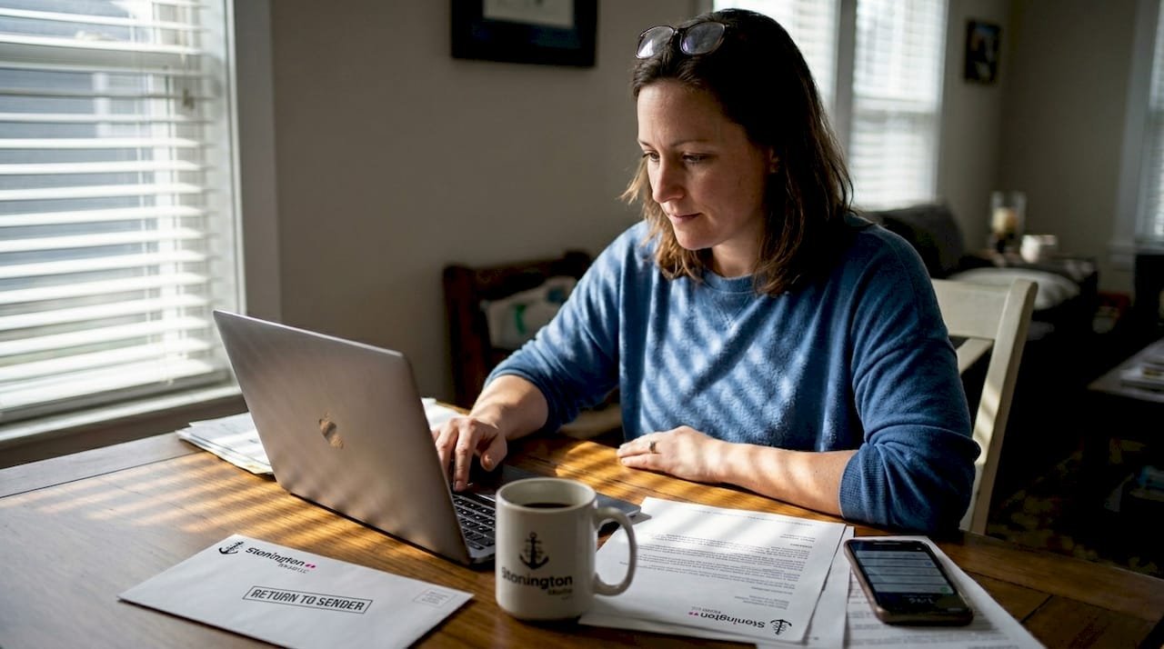Woman sorting email list at home office